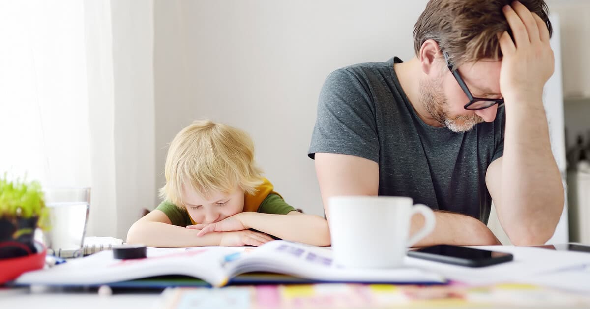 Frustrated father and child sitting at a cluttered table highlighting how ADHD can affect both parenting and learning. Strategic Hypnotherapy from Mindshift Mentors offers support for emotional regulation and family balance.