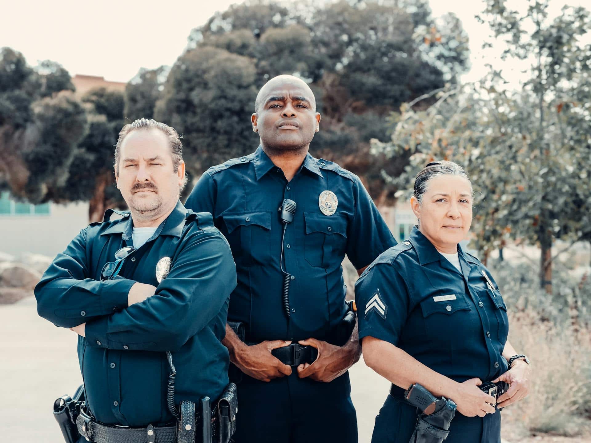 A group of correctional officers stands in uniform, posed in a line with a professional and authoritative presence, possibly during a formal event or briefing.