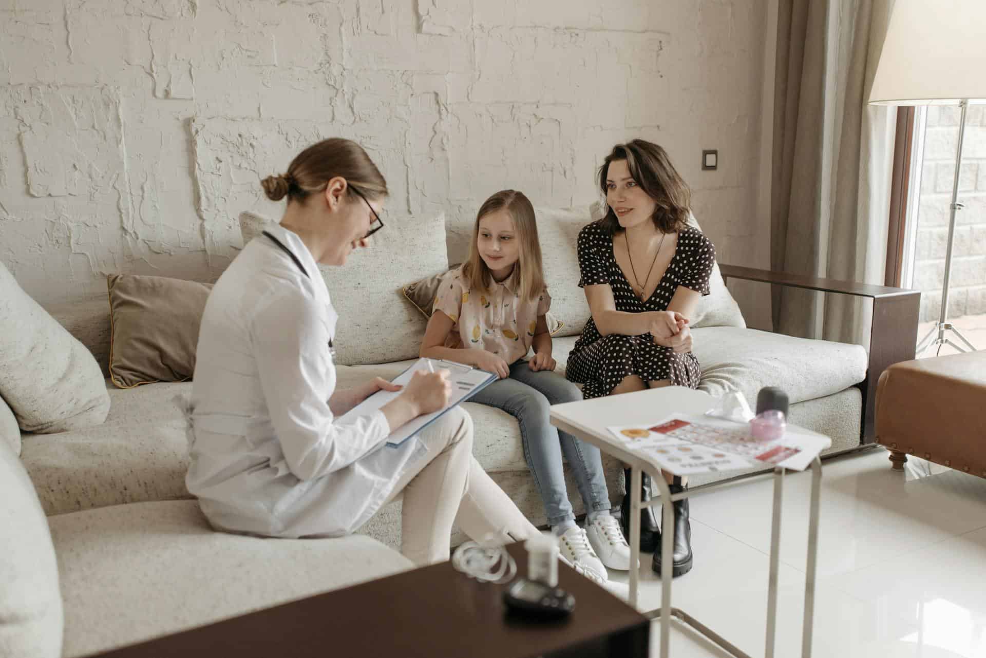 Mother and child consulting a healthcare professional, discussing support options for children with dyspraxia.