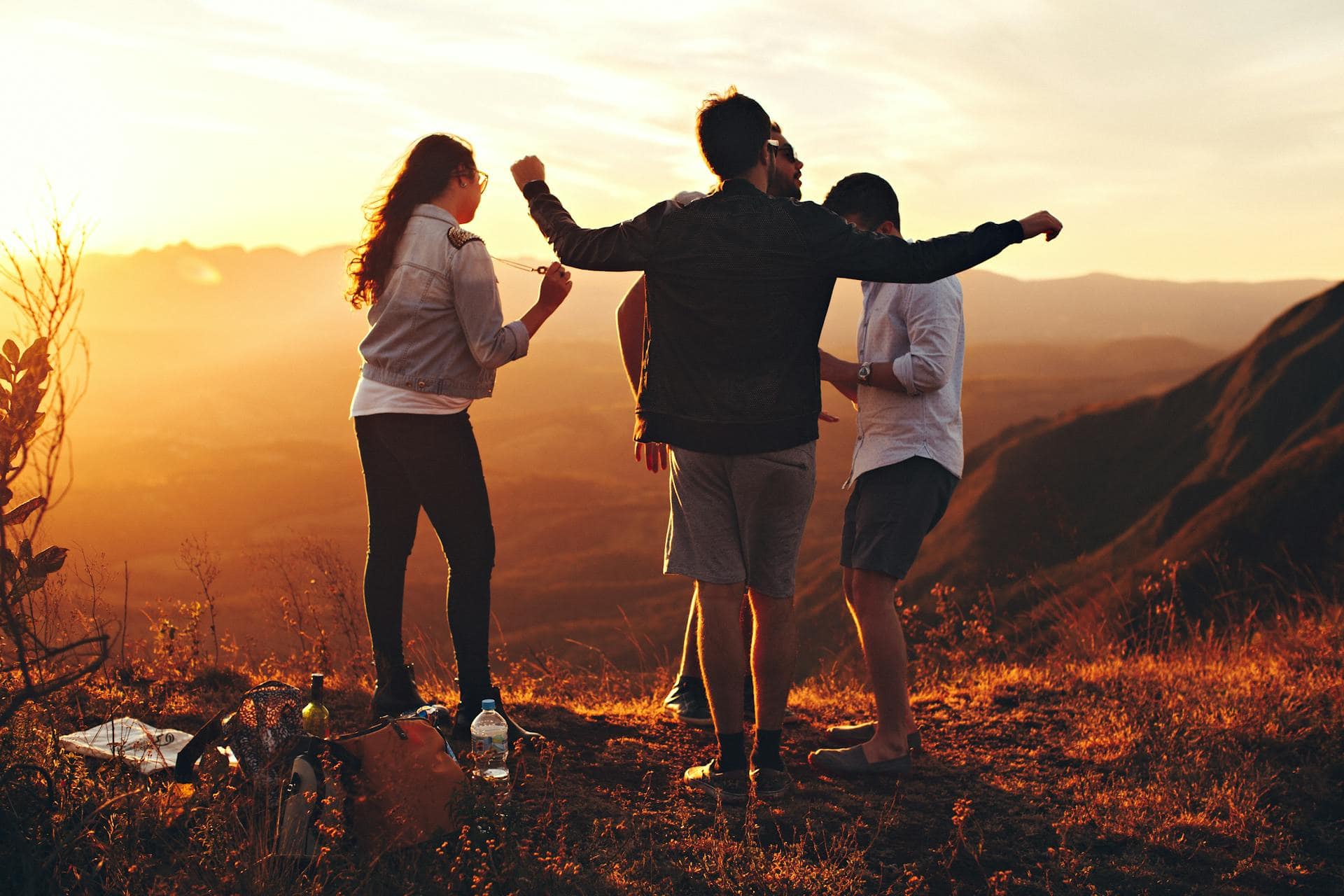 Friends together outdoors at sunset