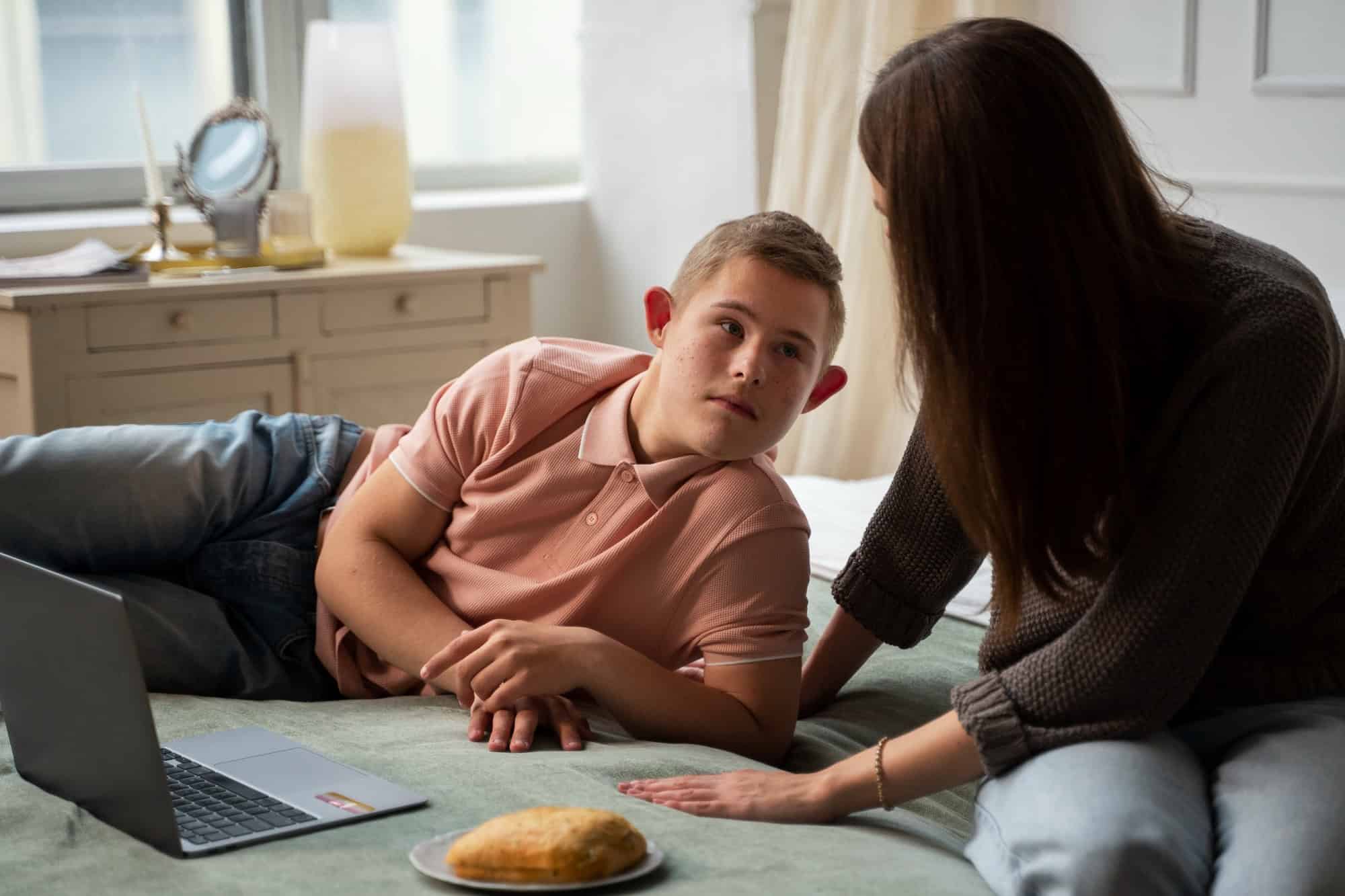 Young person receiving supportive guidance at home while living with Dyspraxia