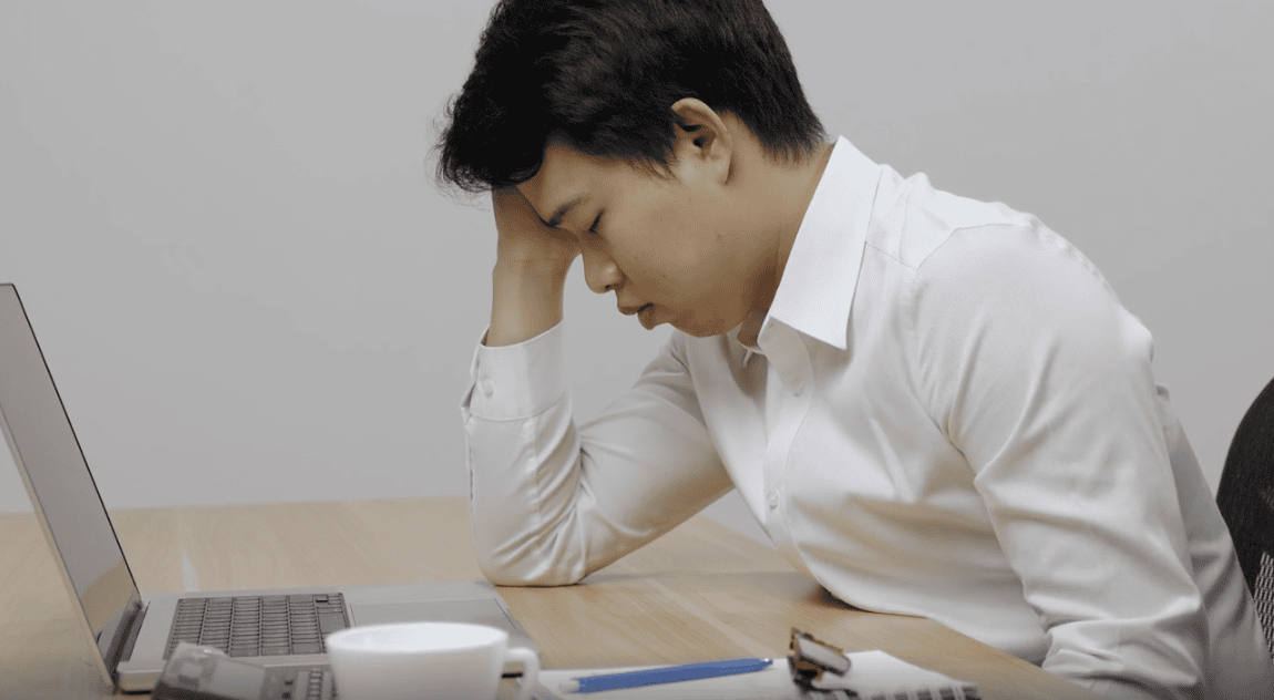 Stressed man at work desk