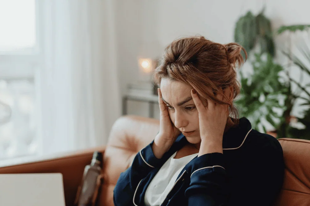 Stressed woman holding head