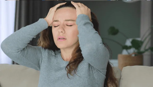 Woman holding head stressed