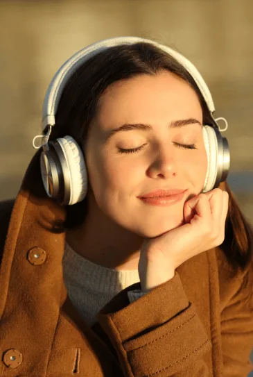 Woman listening to a session with headphones on