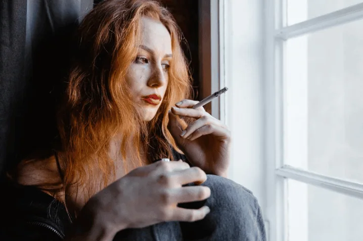Distressed woman with head in hands