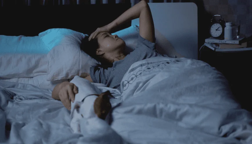 Woman awake in bed in the early hours