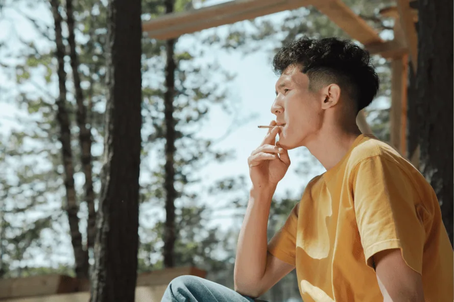 Young man smoking outdoors